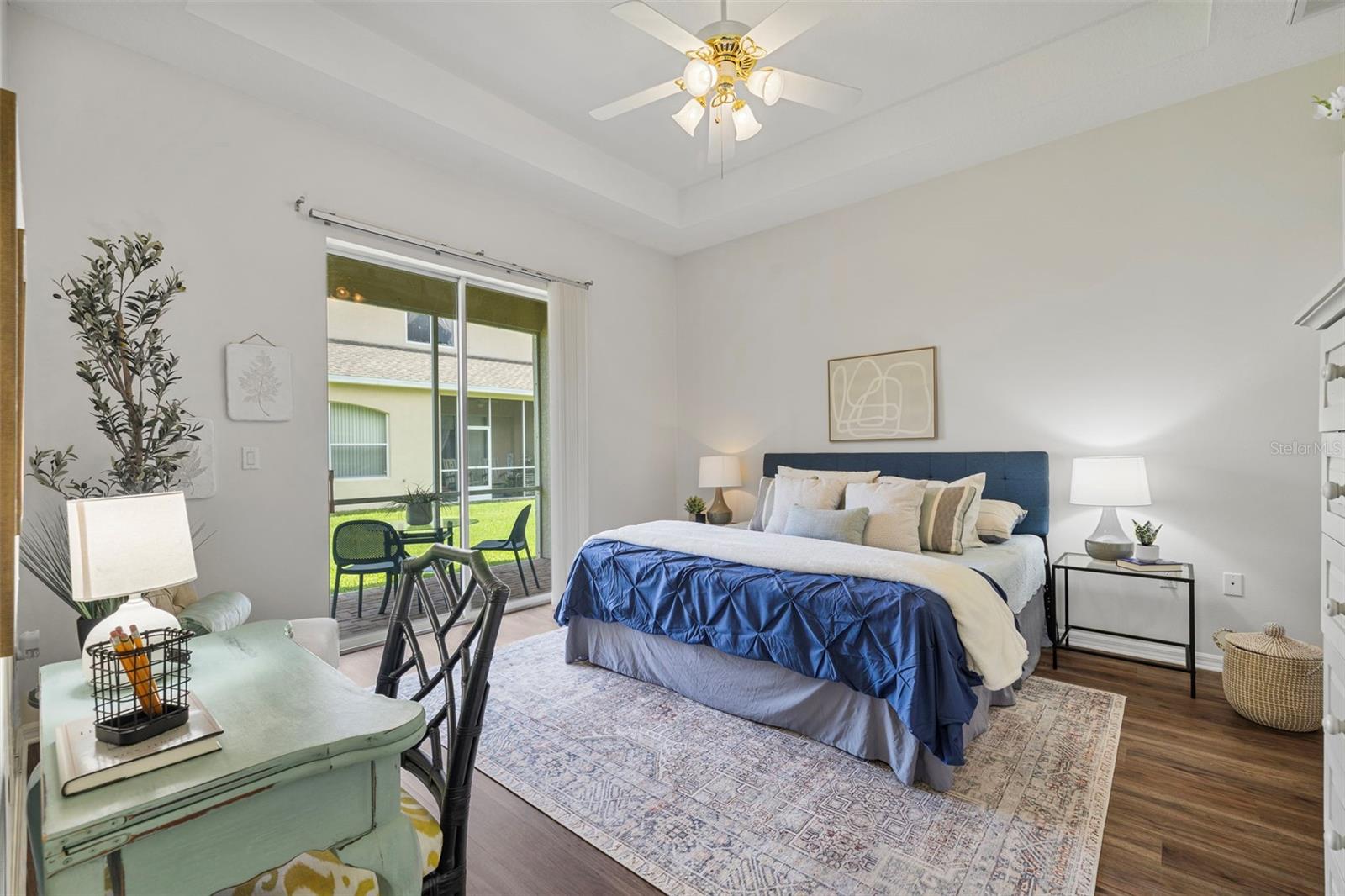 primary suite with slider to the screened patio