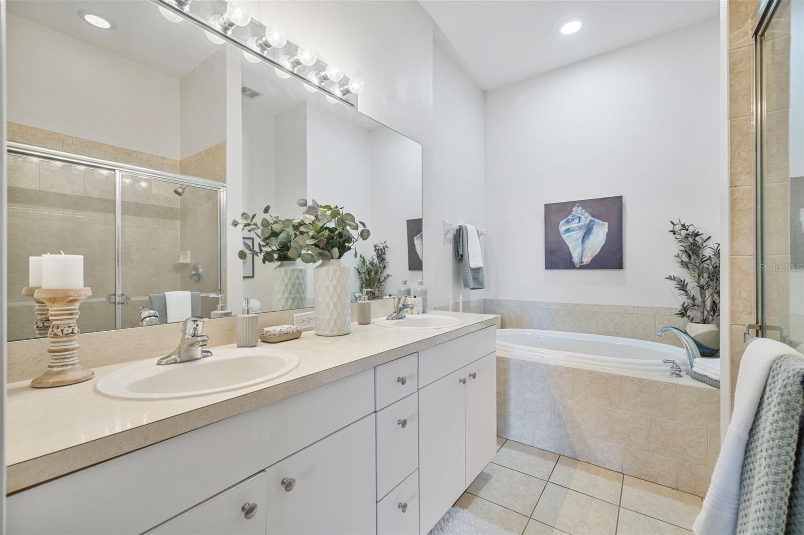 primary bath with double sinks & a soaker tub