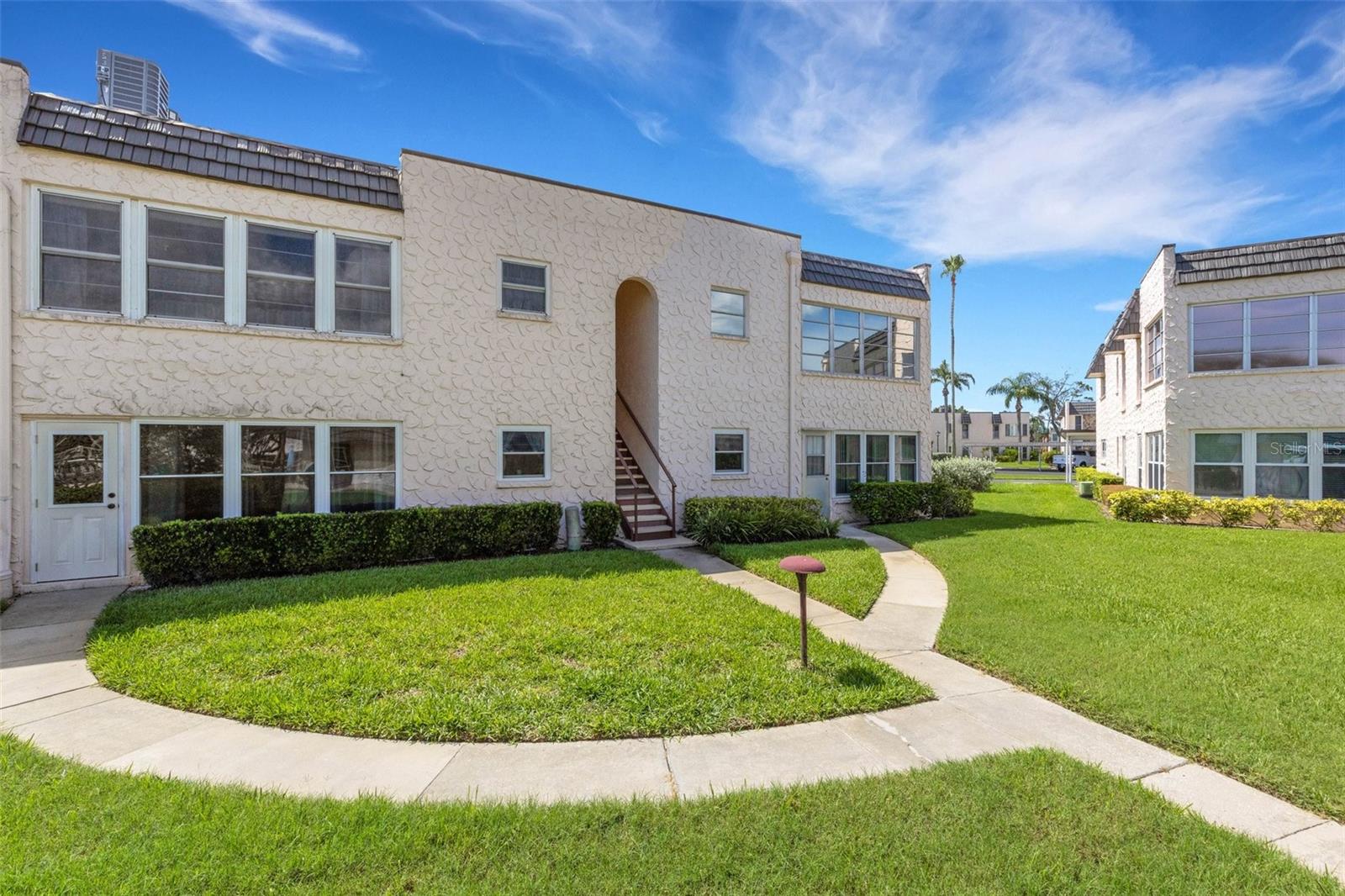 Back Of Unit 221 With Stairway and sidewalk to pool and Clubhouse