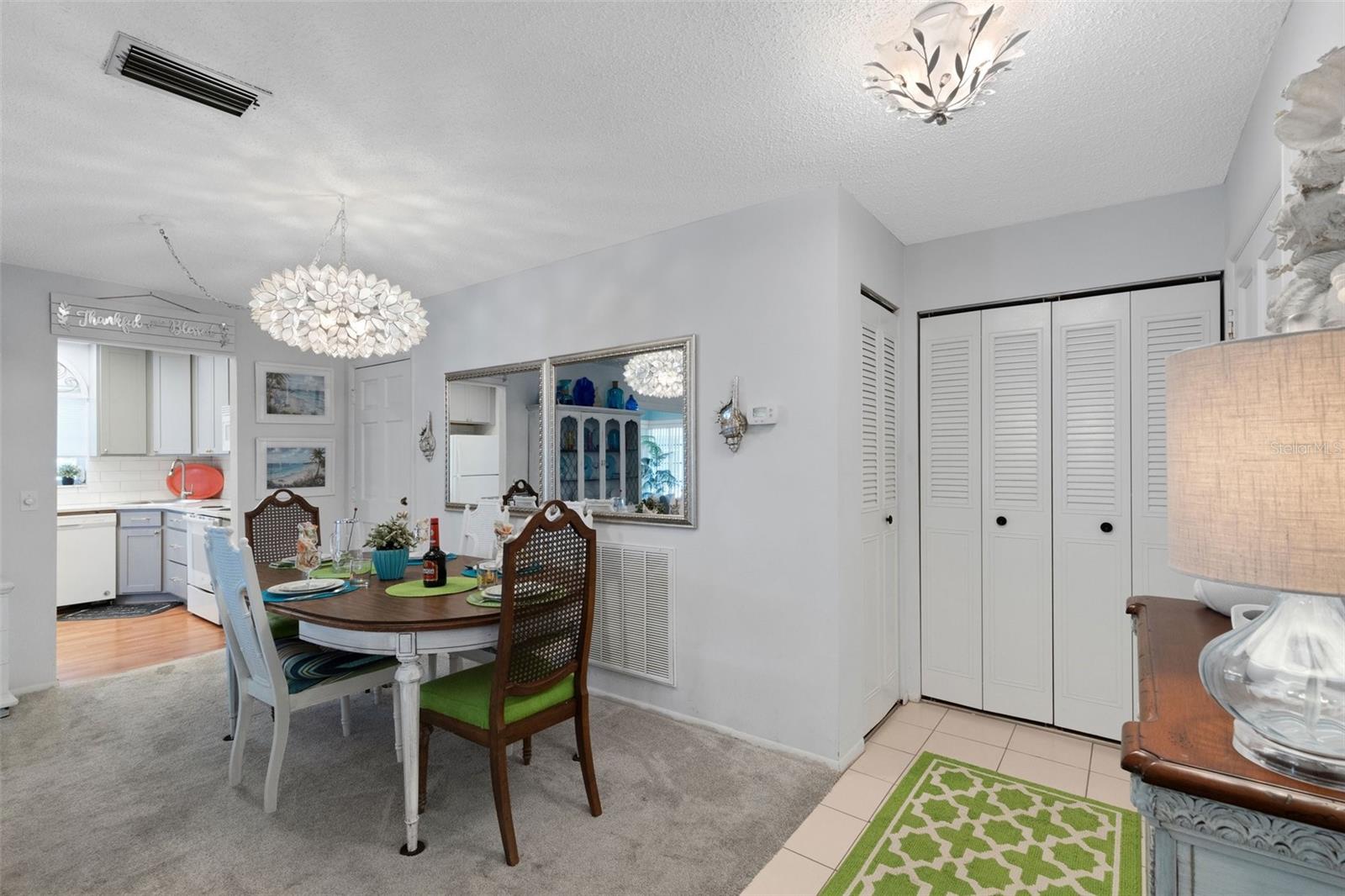 Dining Area With Kitchen Entry on Left and Pedestrian Door to stairway Leading to Walkway to Pool and Clubhouse