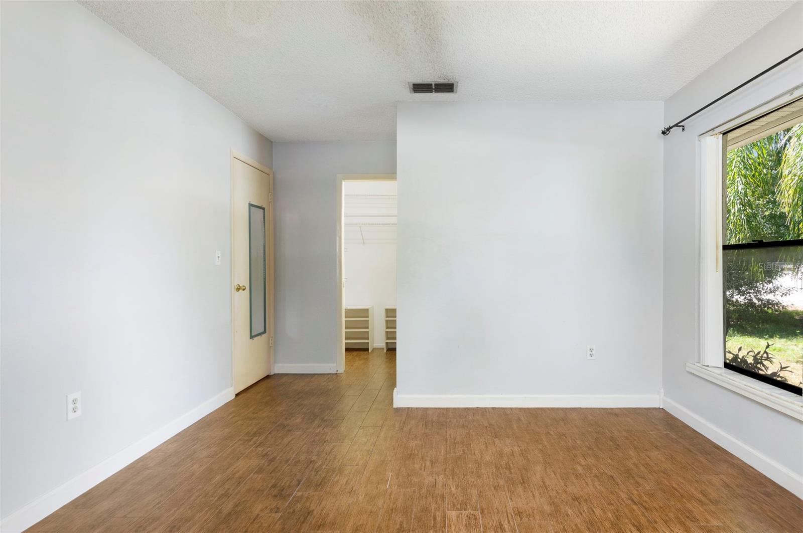 Primary walk in closet and entrance to ensuite bathroom.