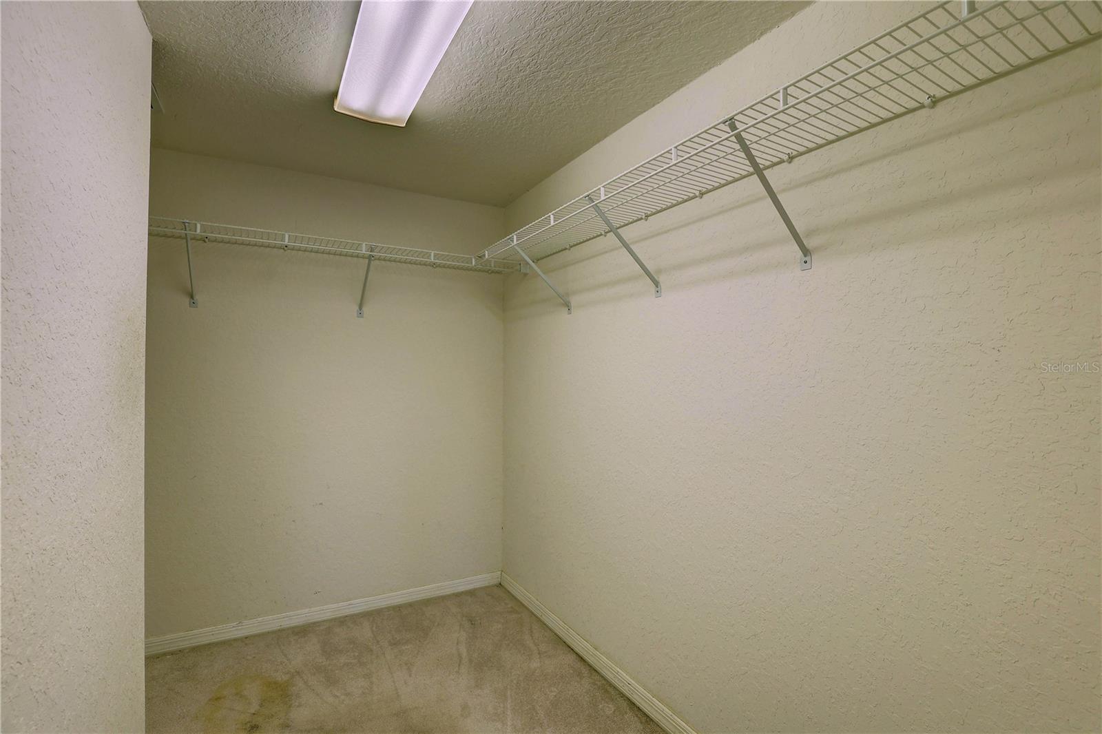 Primary bedroom walk-in closet