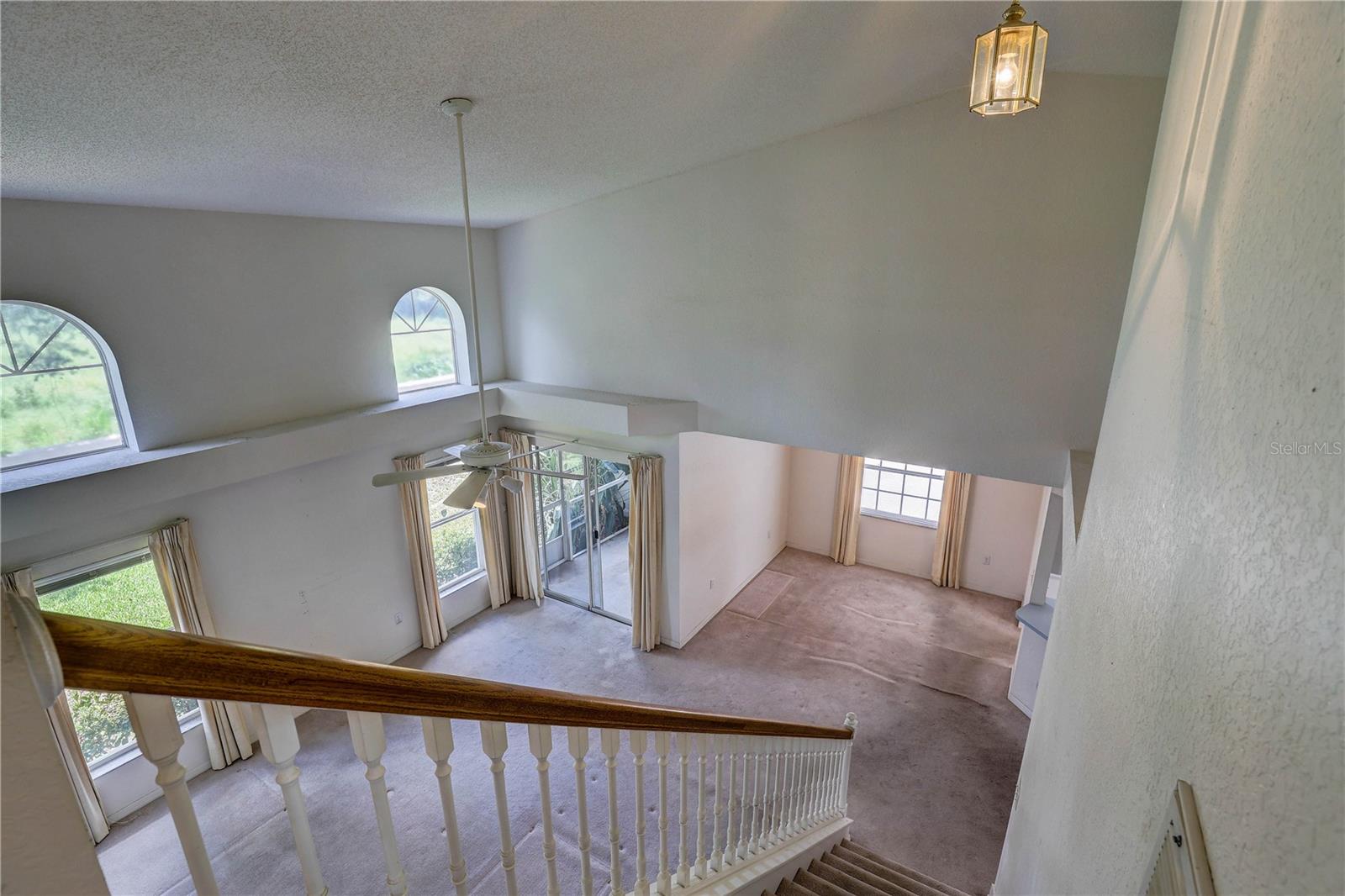 Living area with screened porch in back, and dining room to the right.