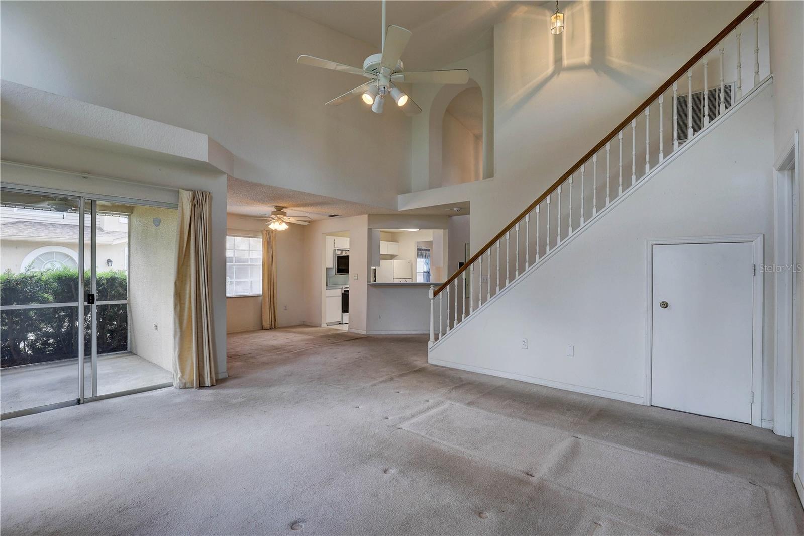 Left to right: Screened porch, dining area and kitchen. Storage under stairs