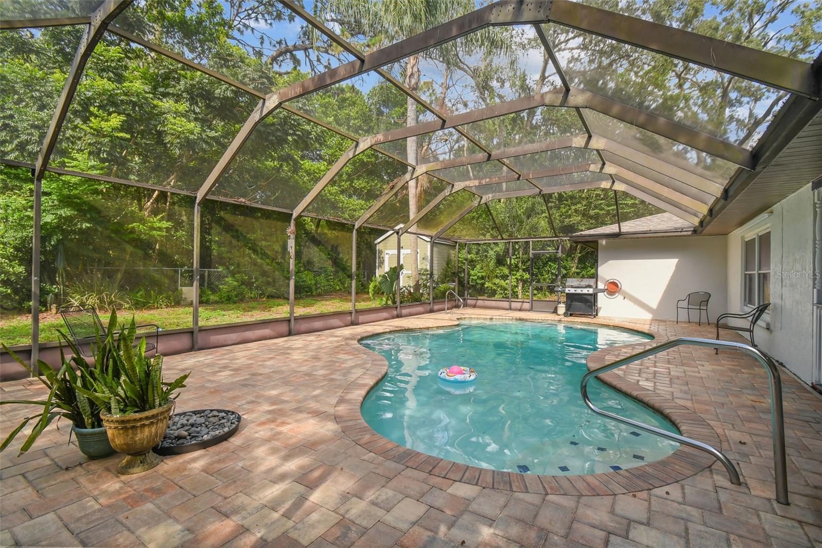 Florida Living...lanai with pavers and recently resurfaced heated pool. Newer pool pump and heater.