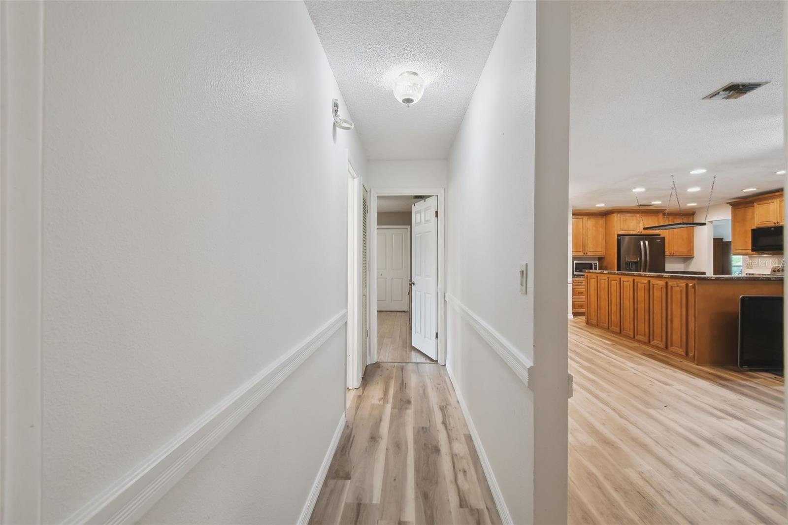 Hallway to secondary bedrooms and second bath