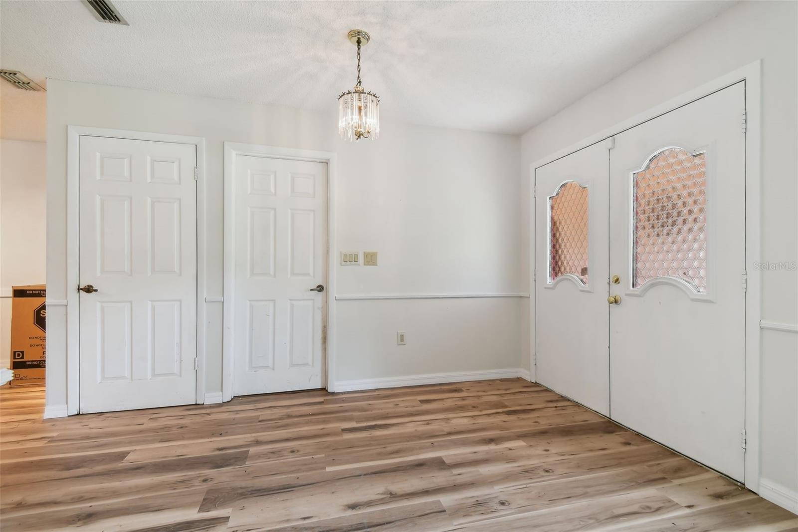 Coat closet on left and garage entrance door on right...garage is converted with partition wall. Can be reverted back to 2-car garage