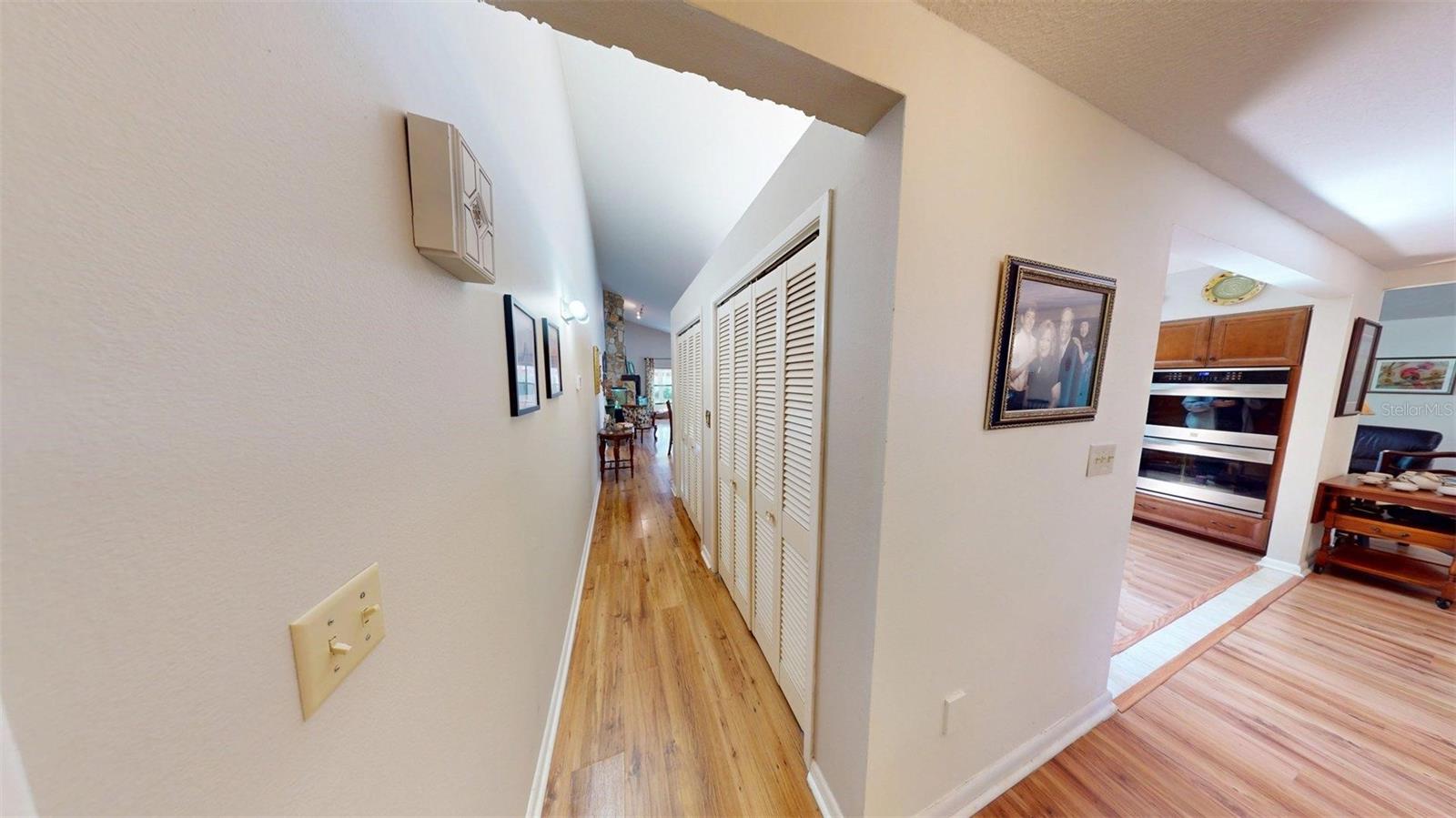Wall of closets behind kitchen