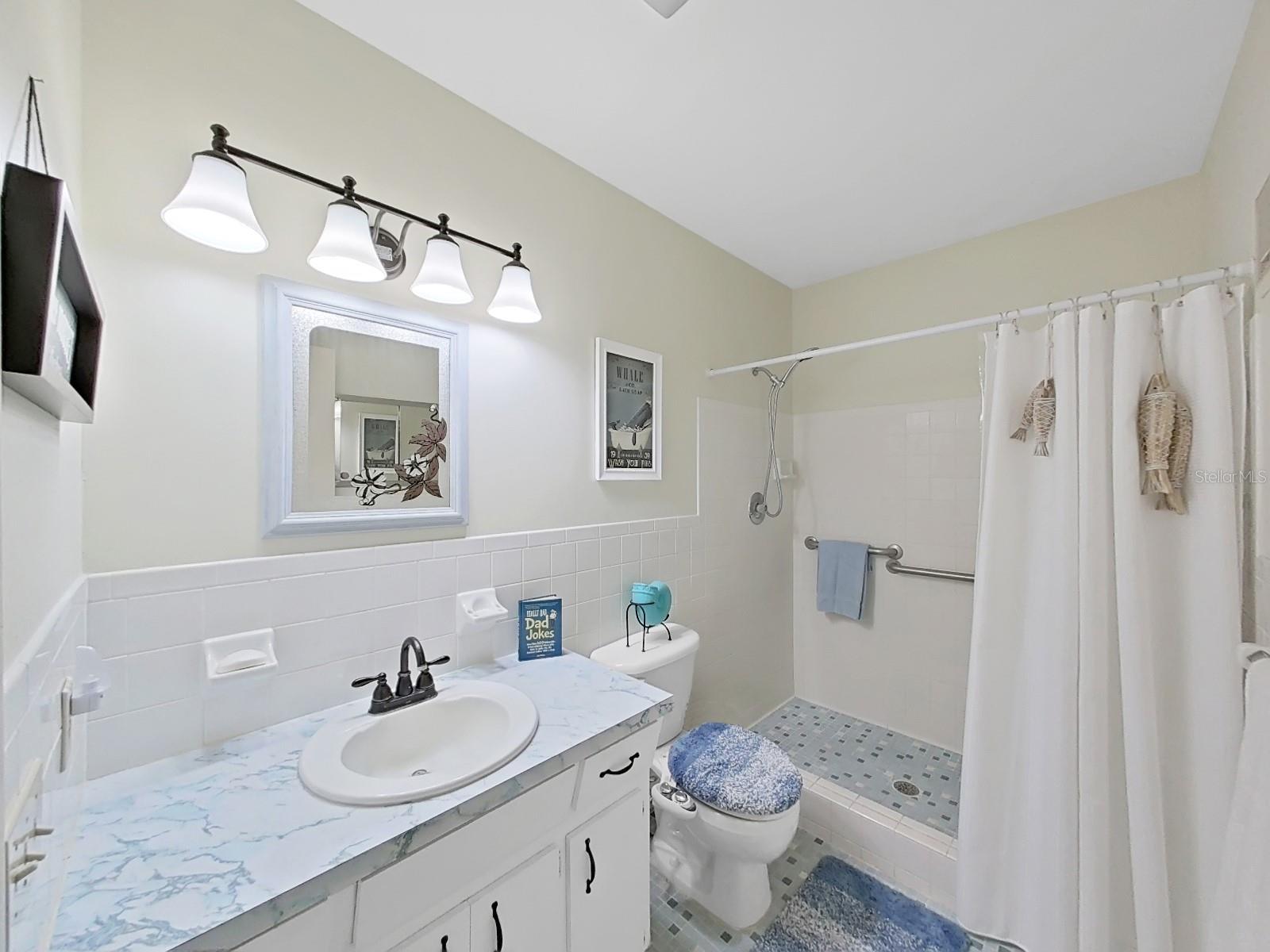 Primary en-suite has a step in shower.