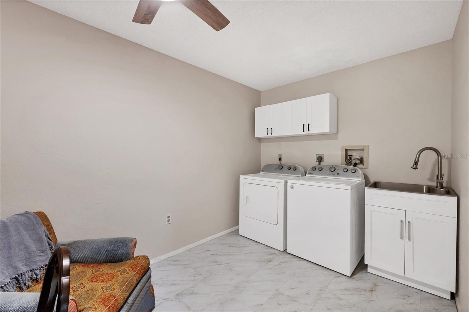Laundry room with wash-basin and storage cabinets
