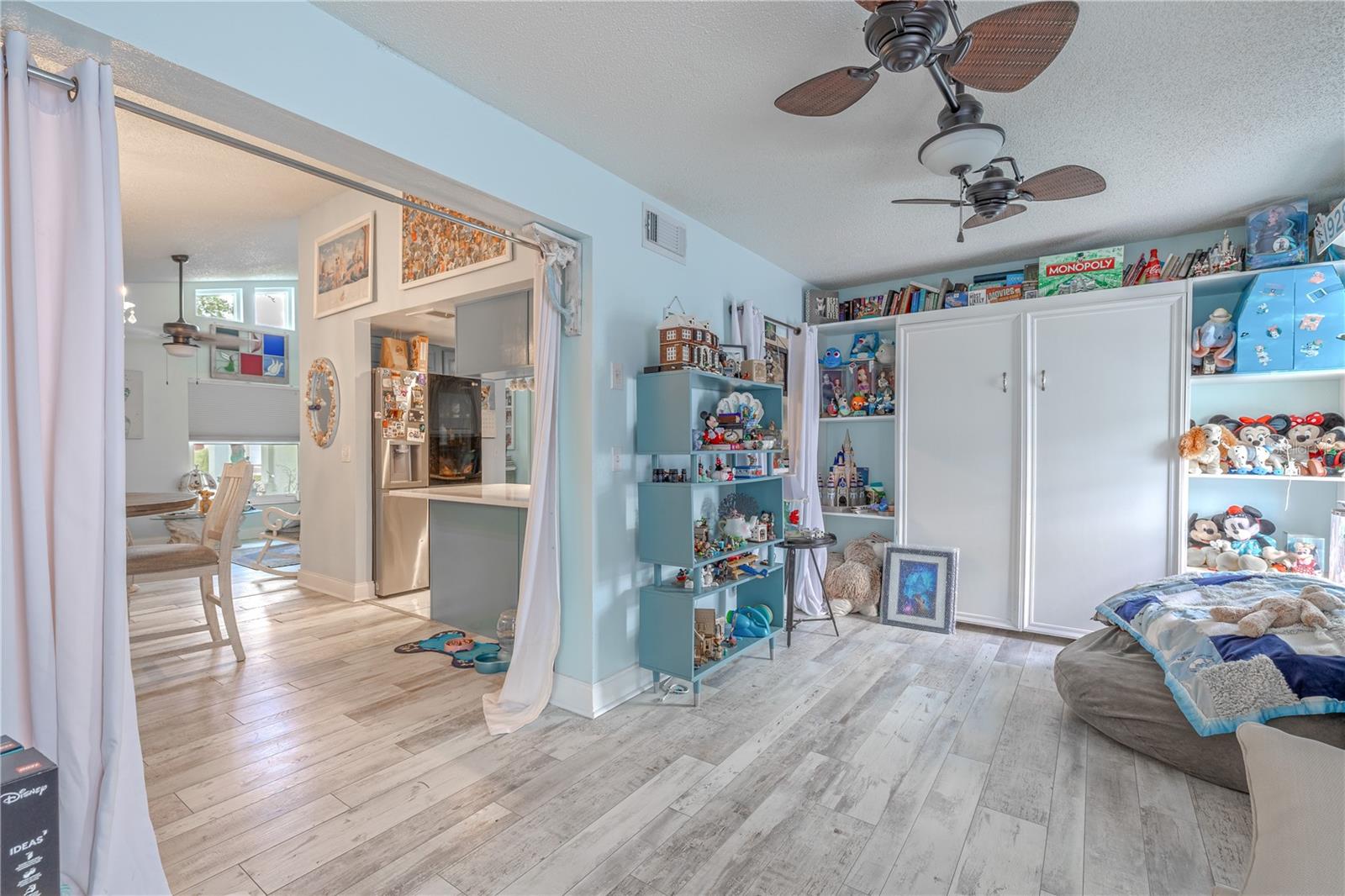 The wood-look vinyl flooring extends seamlessly from the main living areas, creating a cohesive flow throughout the home.