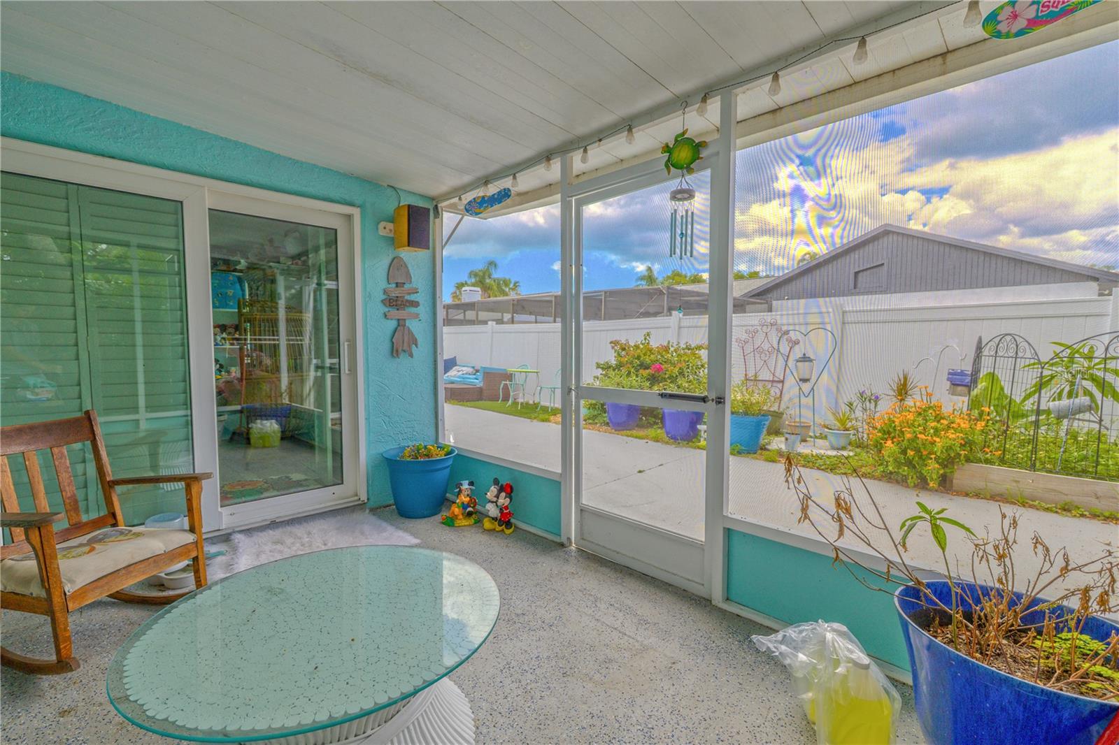 Step outside to enjoy the comfort of a fully screened-in porch, offering the perfect spot to relax while staying protected from the elements. This covered outdoor space features a solid roof and durable flooring, making it ideal for morning coffee, evening drinks, or simply enjoying the breeze. Sliding doors provide a seamless connection to the interior, while large screen panels offer views of the patio and landscaped backyard