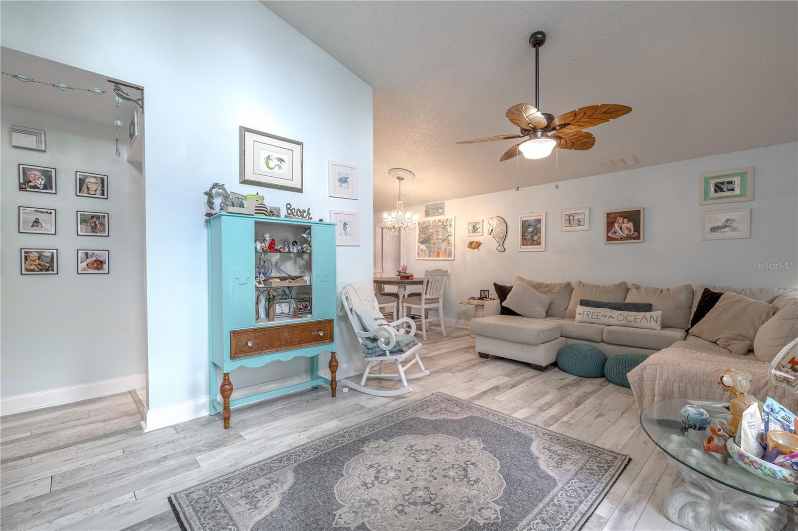 Stylish wood-look vinyl flooring adds durability and easy maintenance while lending the room a modern, beachy feel.