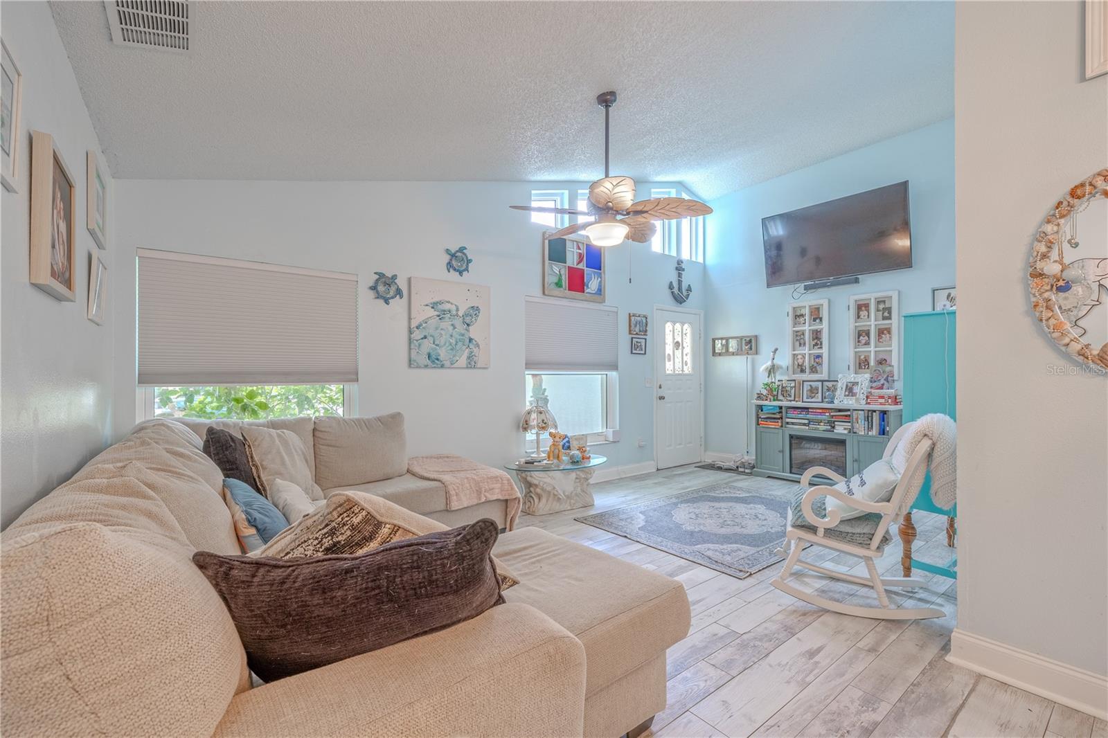 The living room layout is ideal for both relaxing and entertaining, with ample space for a sectional and cozy conversation areas.