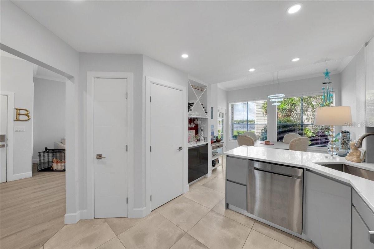 master bathroom with glassed-in rainfall shower head. Floating vanity, linen closet.