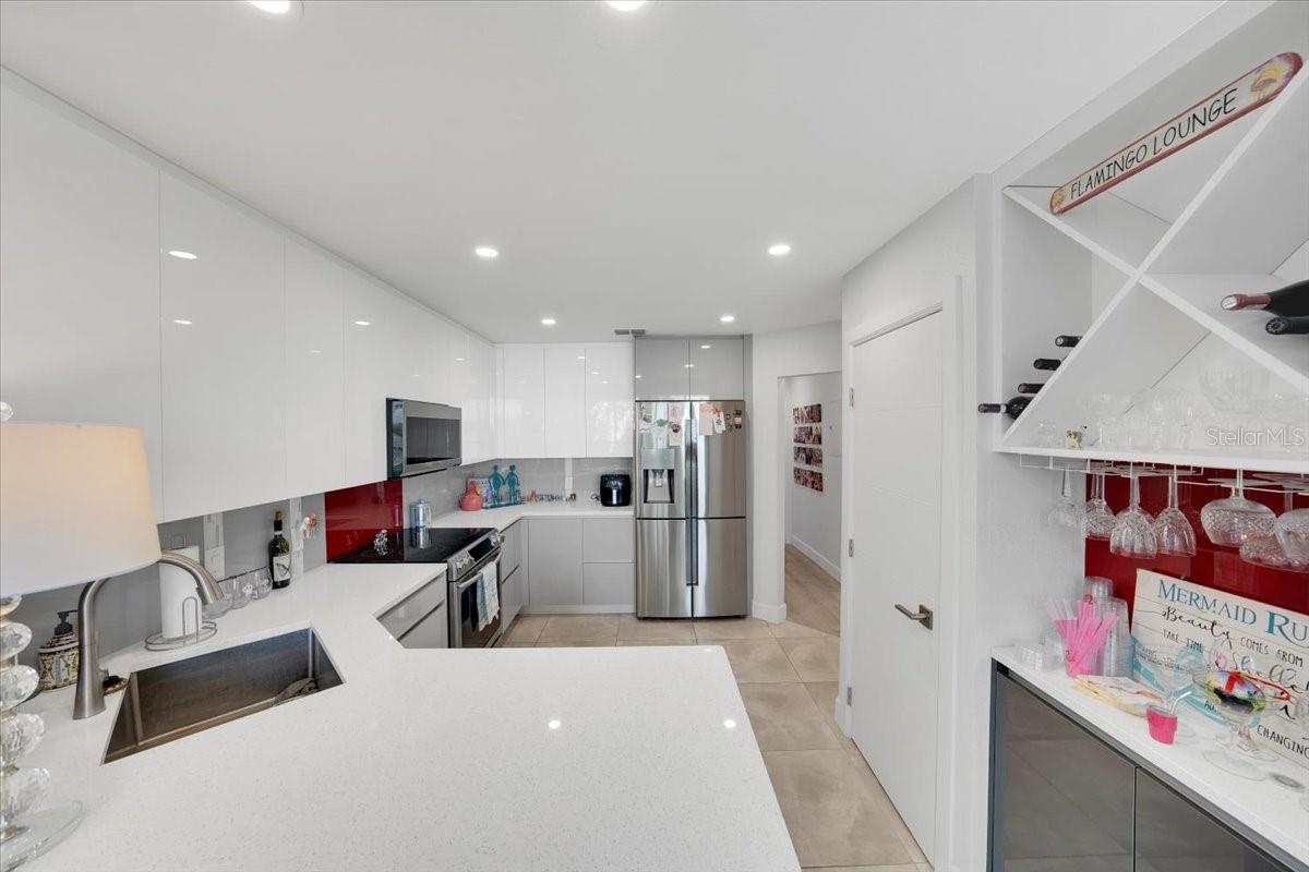 Kitchen area fully renovated with pantry, high grade SS appliances, quarts countertops, wood cabinetry with built in features!