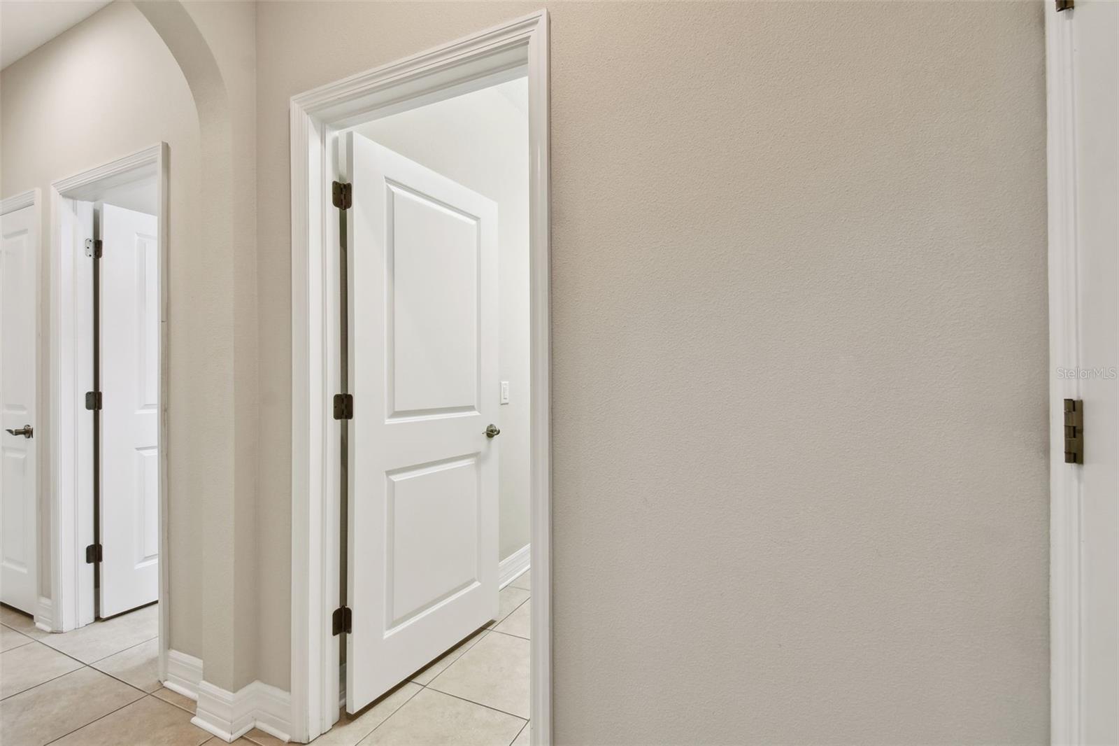 Hallway to in-law suite, full bathroom, and laundry room!
