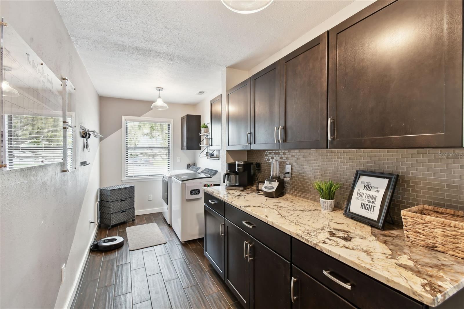 Beautiful wood cabinets and designer granite make this laundry room truly spectacular.