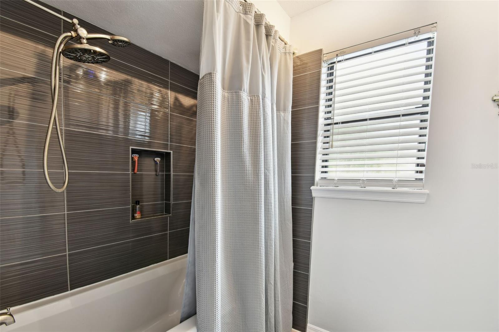 Secondary bathroom - tub with shower. Designer fixtures and finishes.