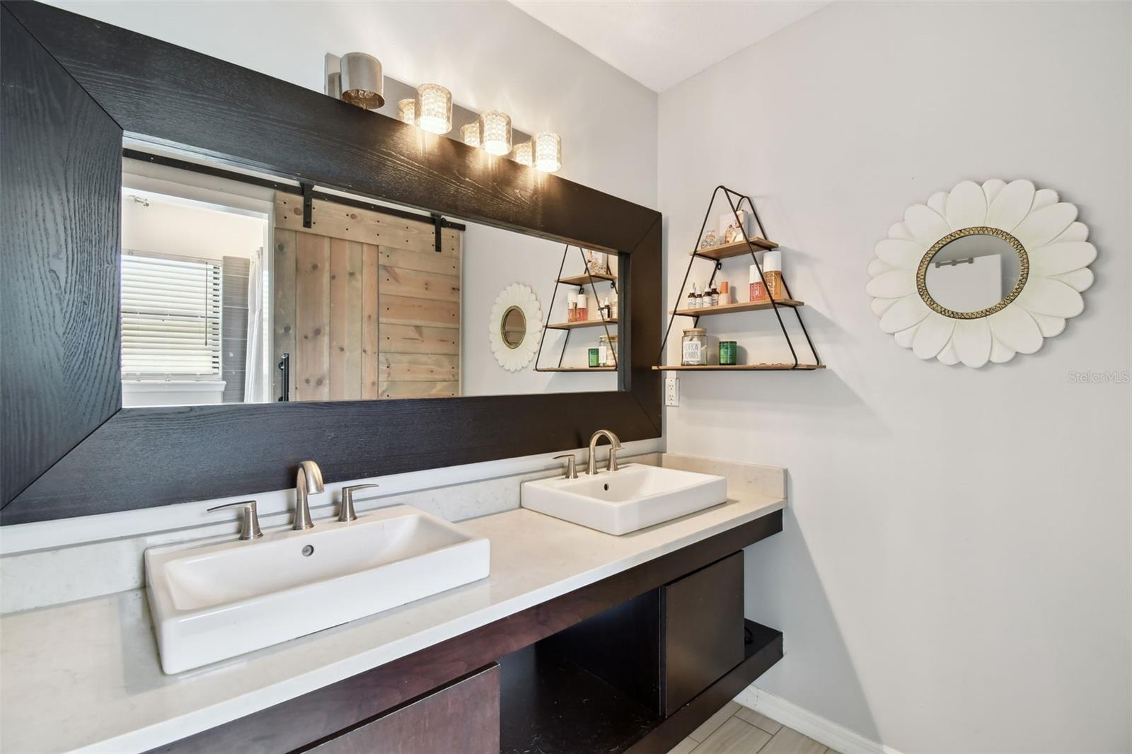 Unique, yet practical, double sink vanity in the second bathroom. Decorator fixtures and finishes. Lots of counters and storage.