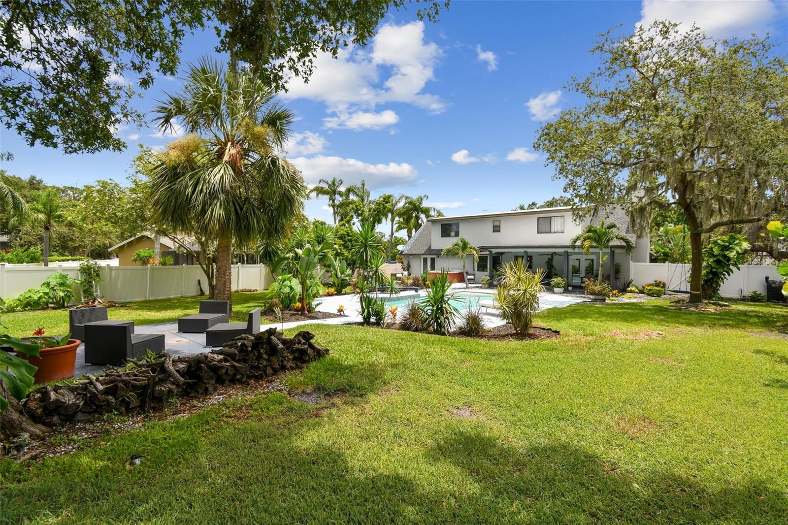 Out past the pool is a cozy seating area with fire pit.