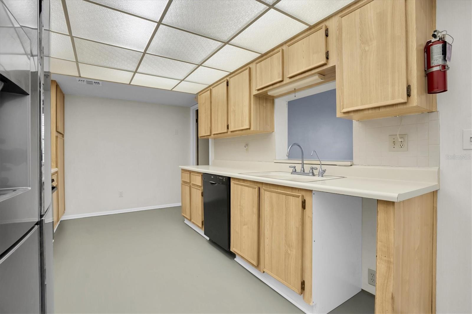 Kitchen area with pass through window looking into the family room/den area