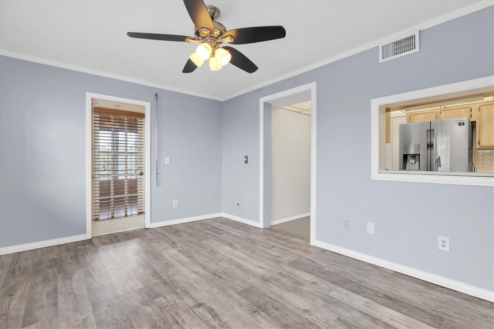 Family room/den with the kitchen passthrough, kitchen doorway, and an additional door to the all season patio