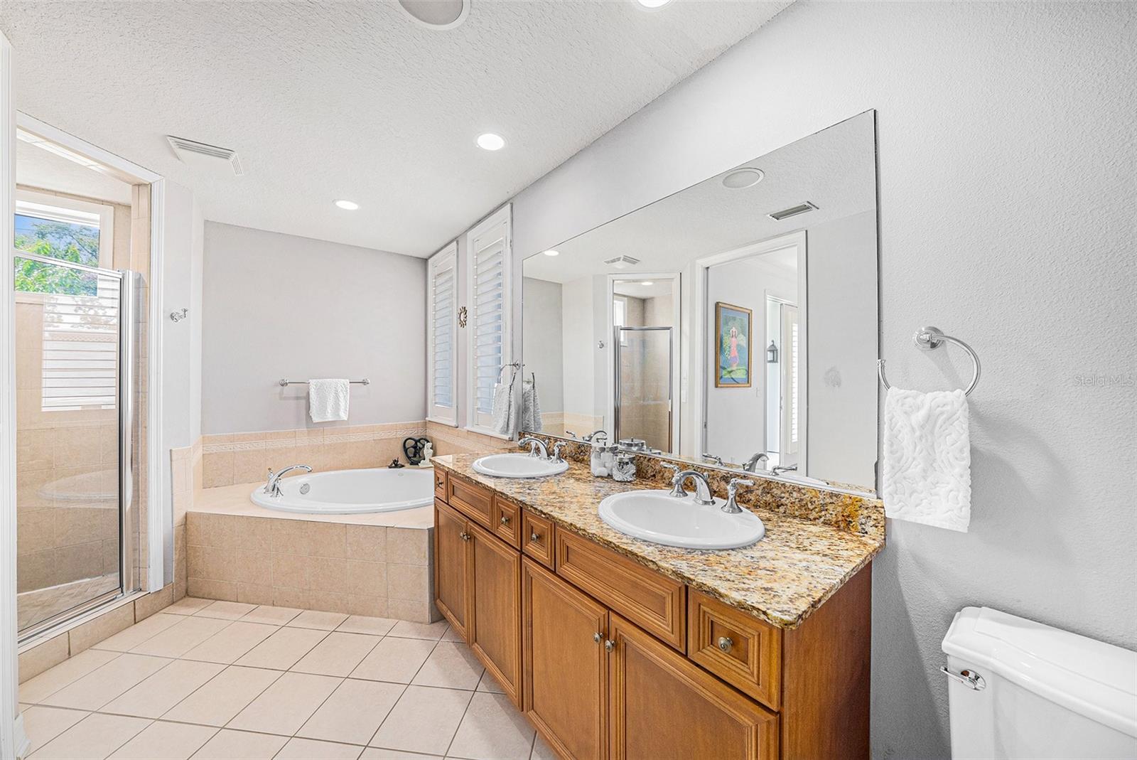 Primary bathroom with dual vanity and soaker tub