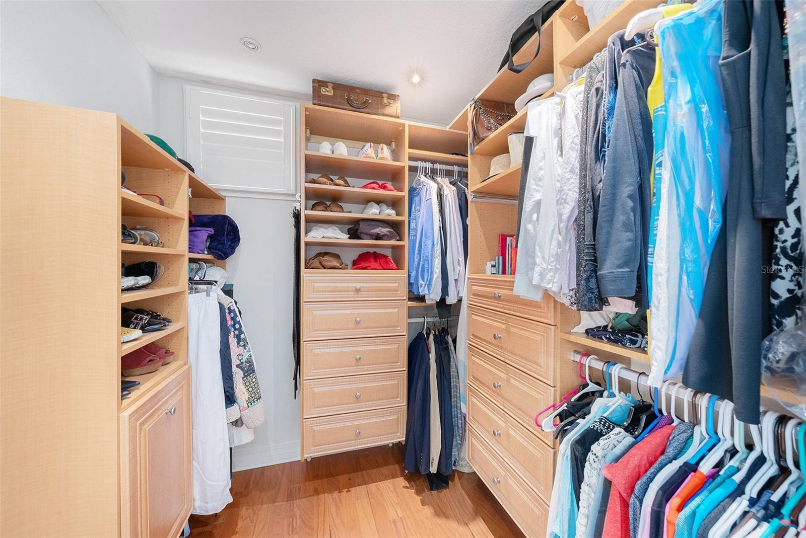 Primary closet with custom closet organizer