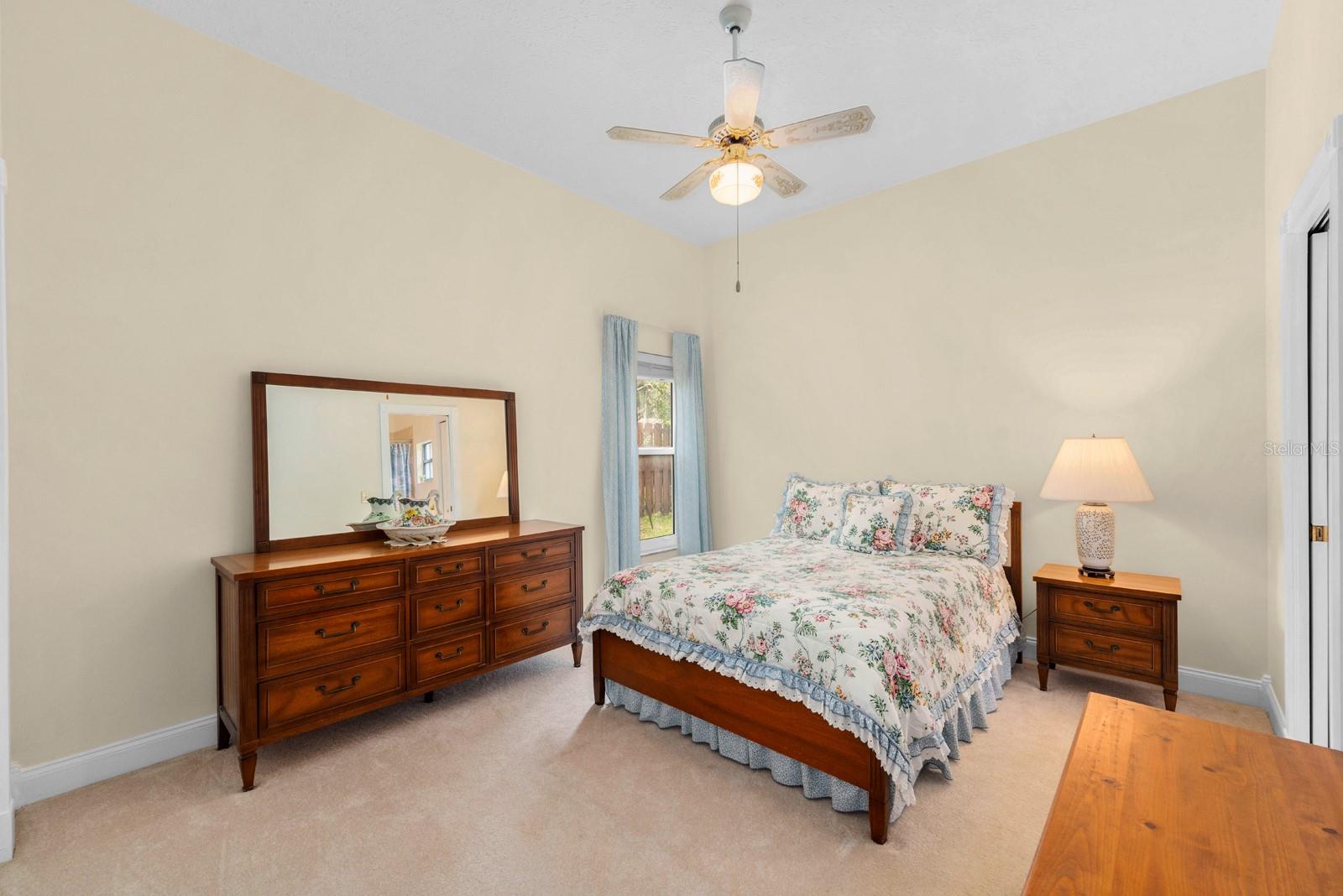 Bedroom 3 is spacious and features a lighted ceiling fan.