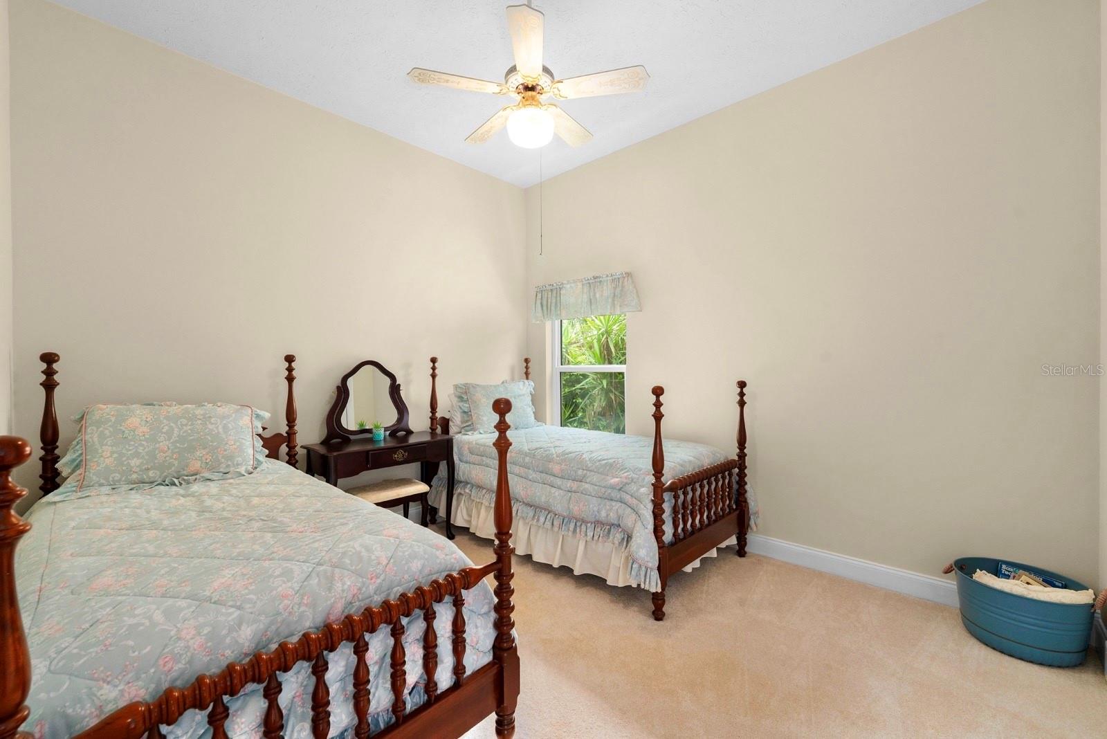 Bedroom 4 is spacious and features a lighted ceiling fan.