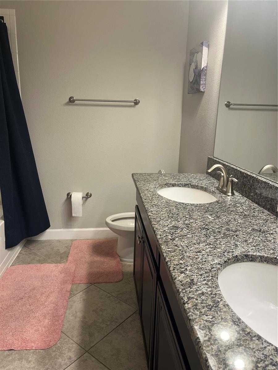 Upstairs full bath with double sinks and linen closet