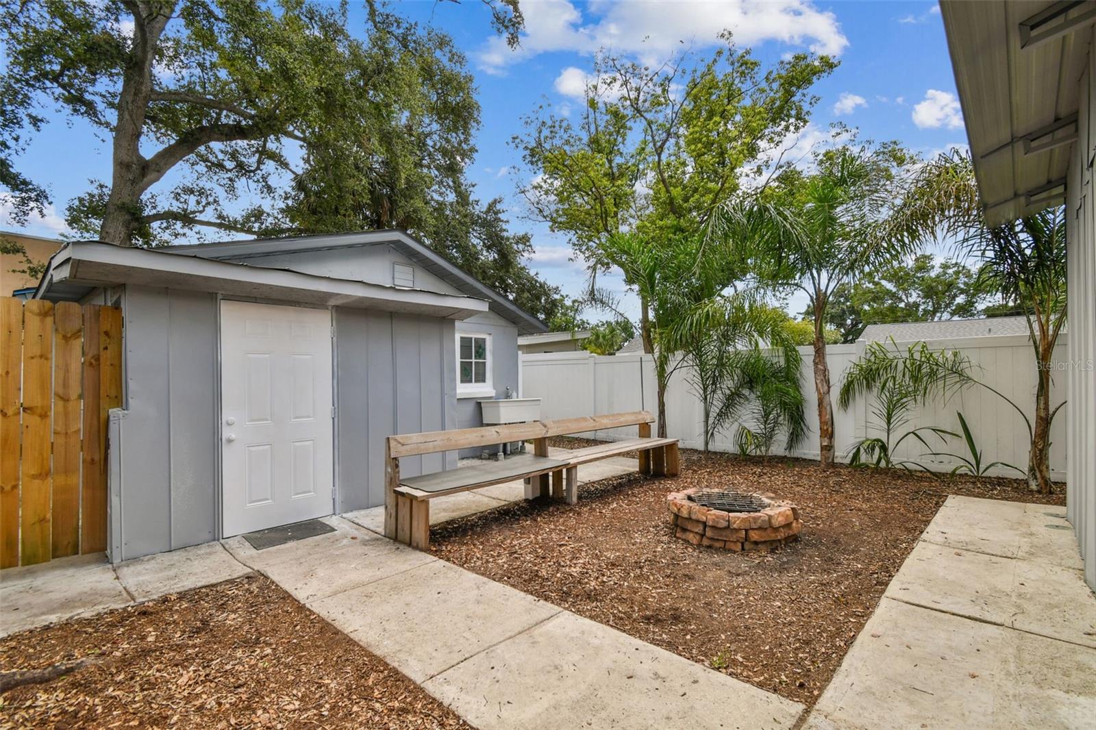 Fire pit with Bench off of guest cottage