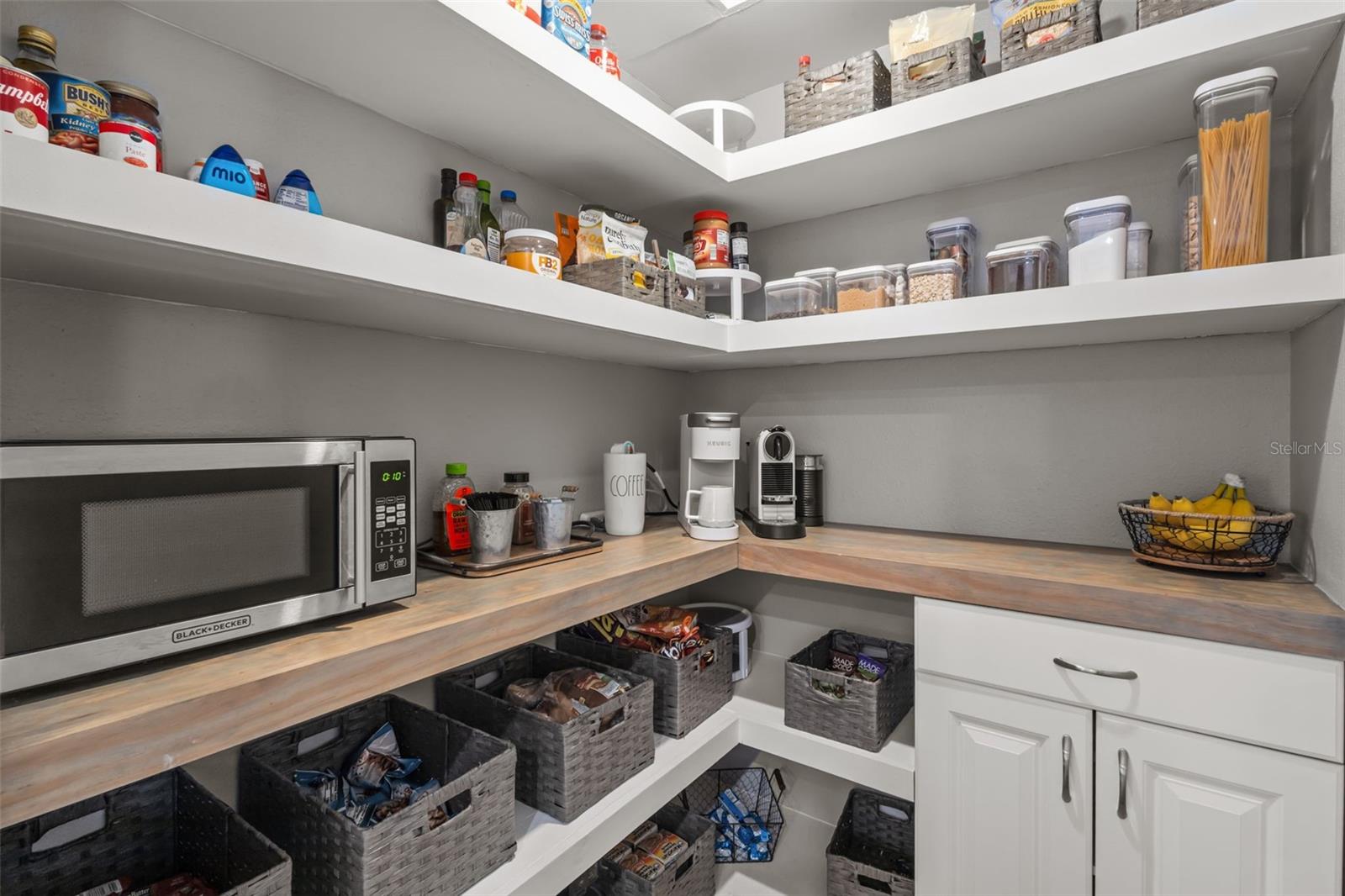 Walk in Pantry with custom wood shelving and cabinets