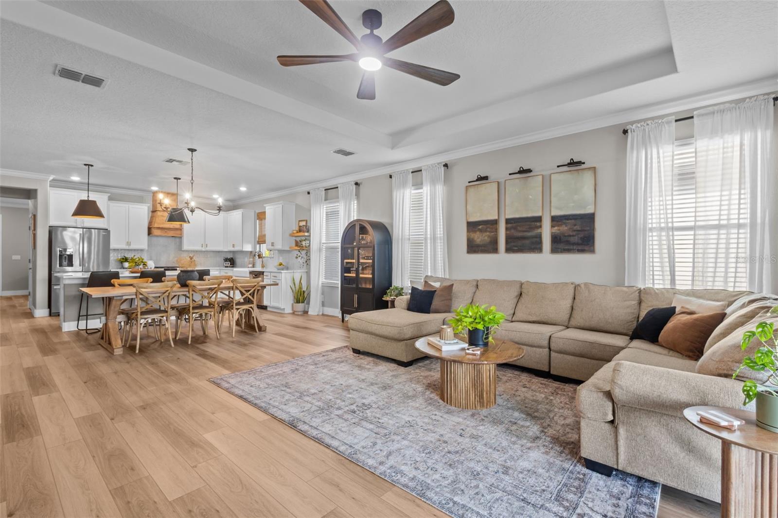 Larger view of living, dining, and kitchen open space