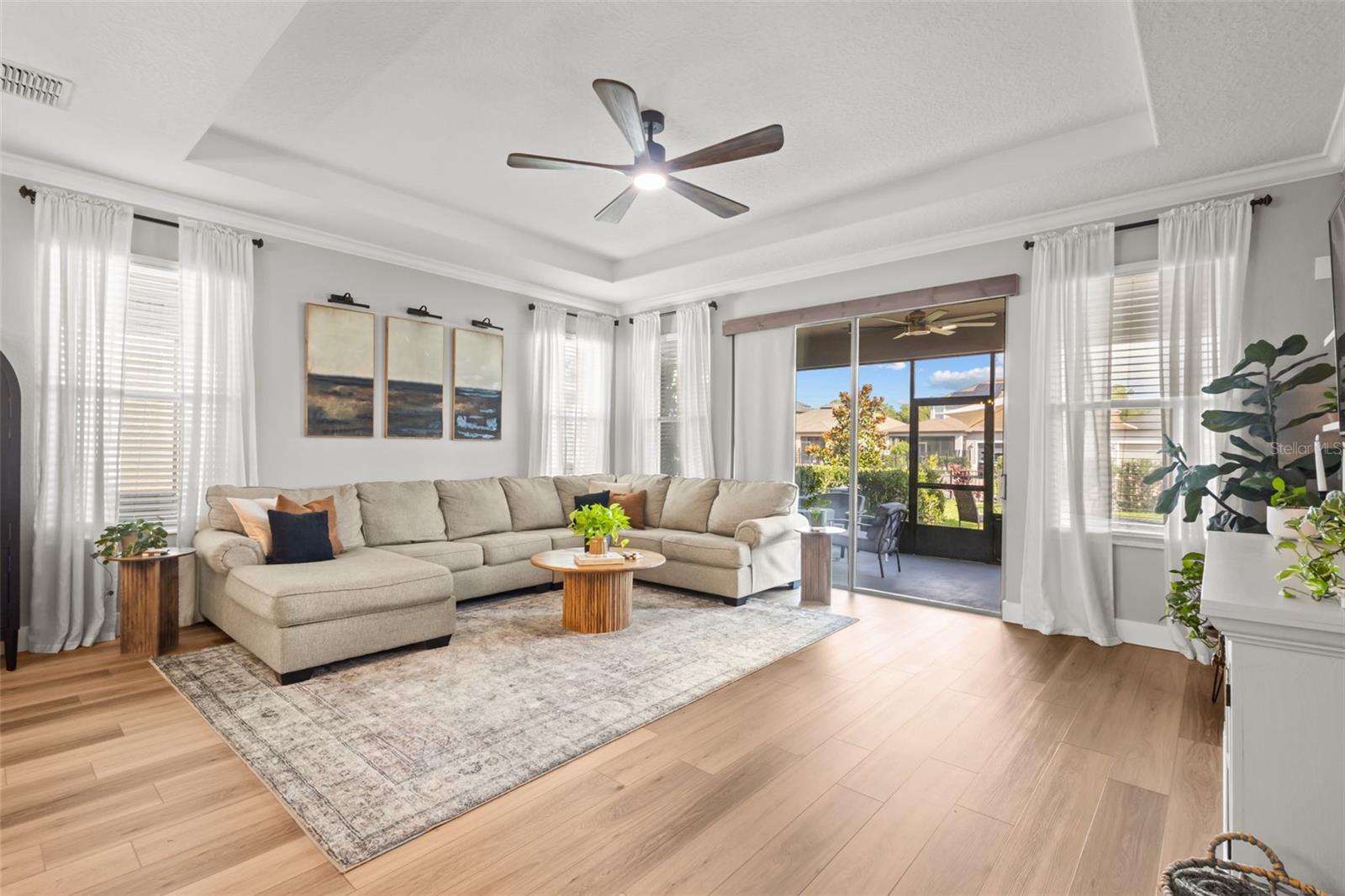 Living Area with reay ceiling and sliders to the rear screened in patio