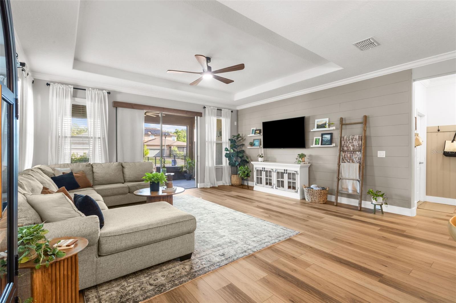 Living Room has tray ceiling and shiplap feature wall