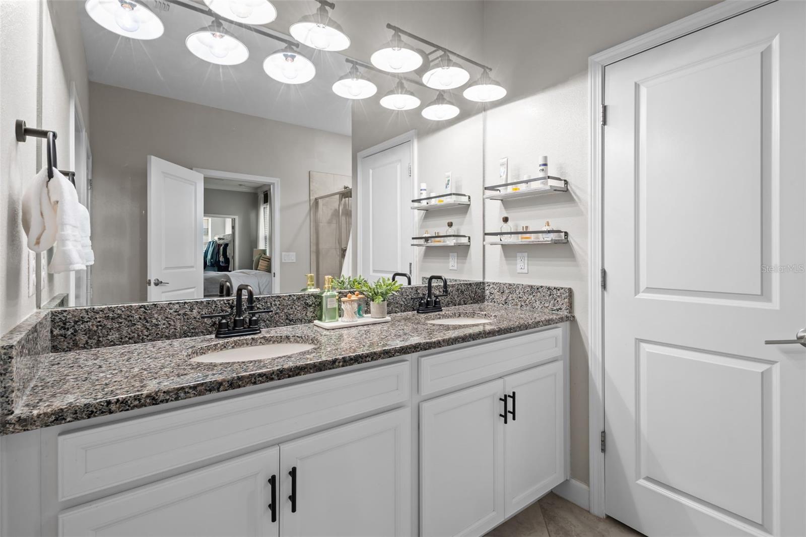 Primary en suite bathroom with double sinks and walk in shower - door pictured here is the 2nd closet