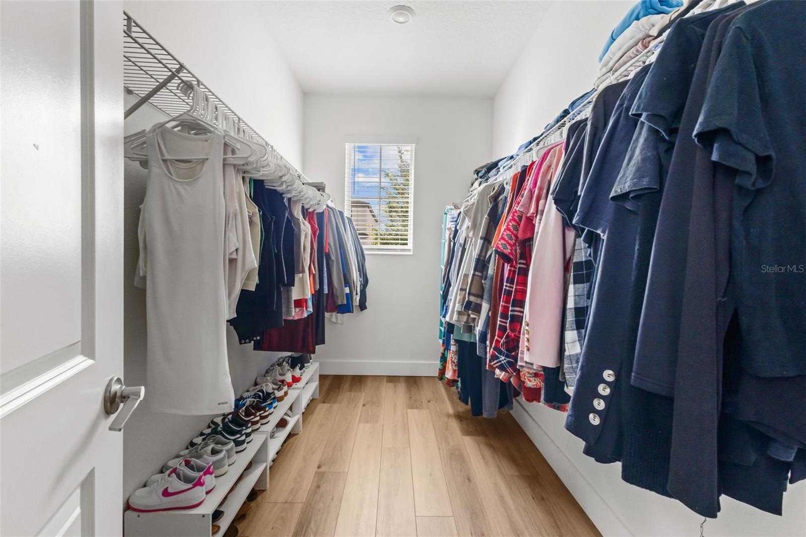 Primary bedroom walk in closet