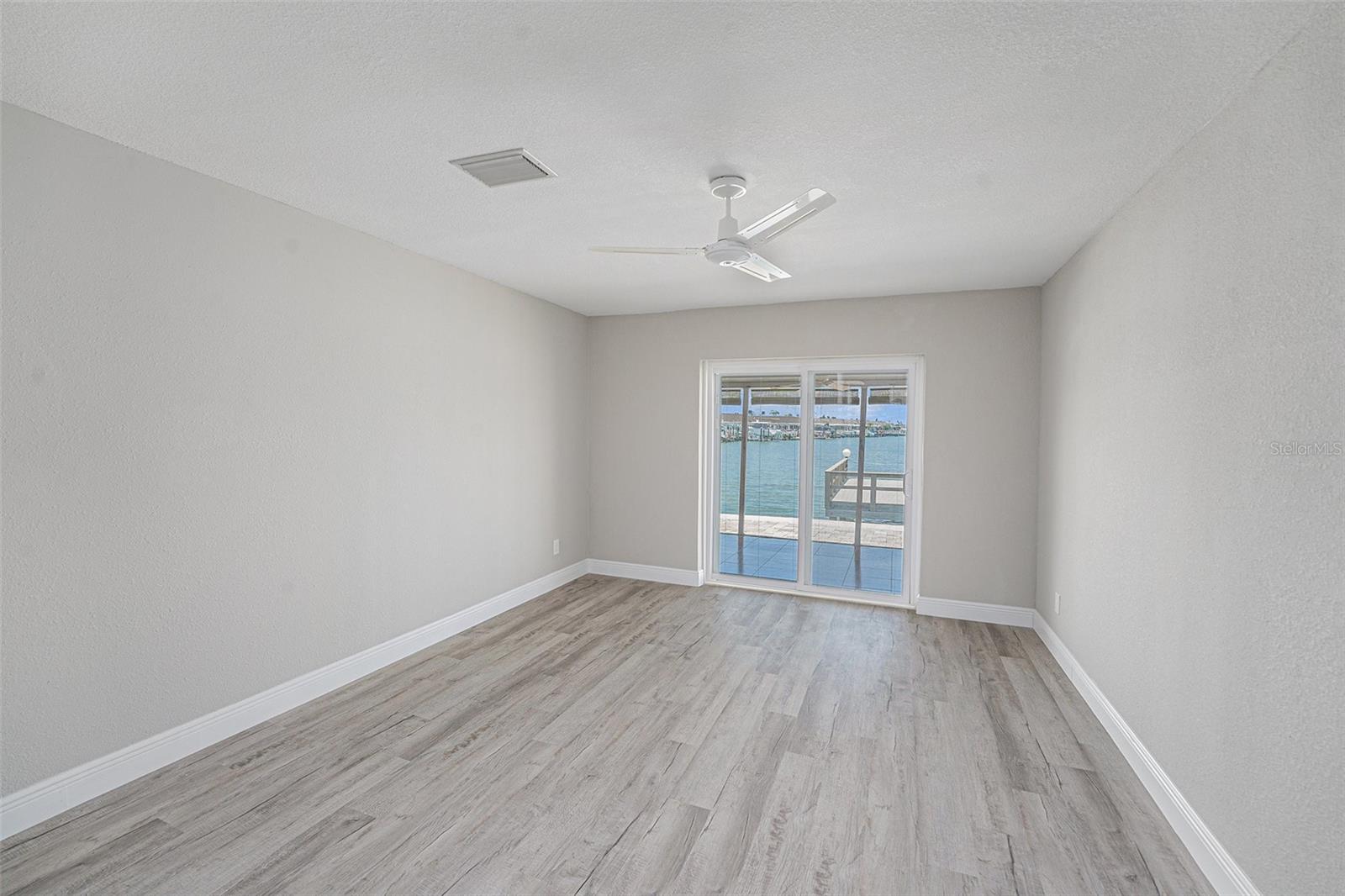 Bedroom 3 with sliders to waterfront