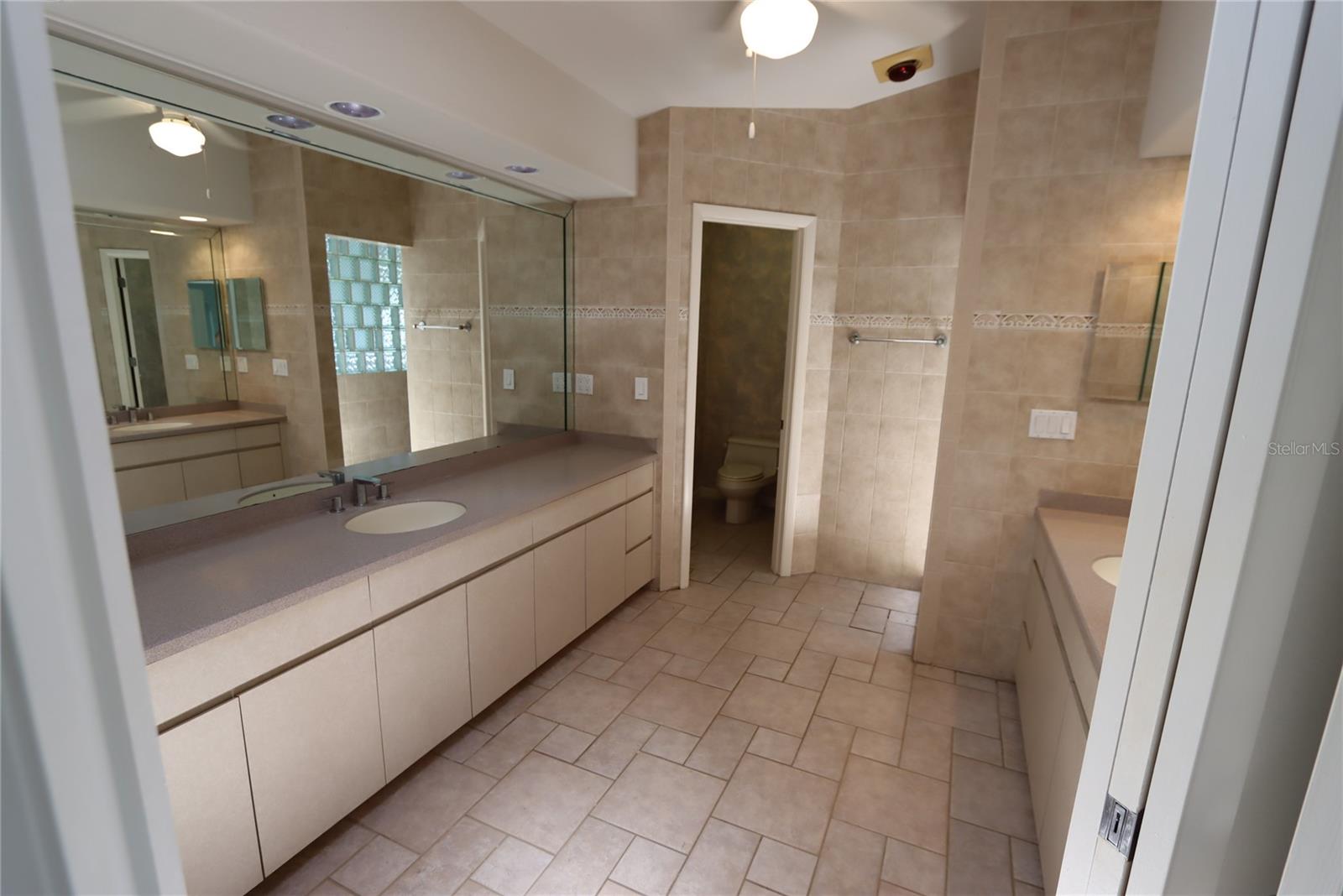Primary bath view facing water closet and shower