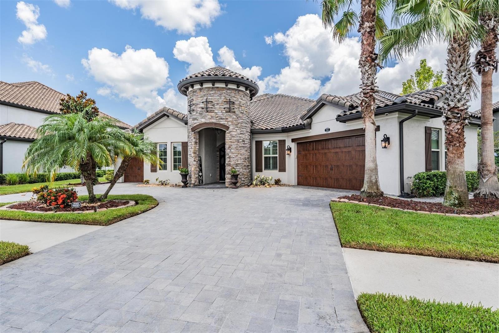 paver circle drive and lush landscaping