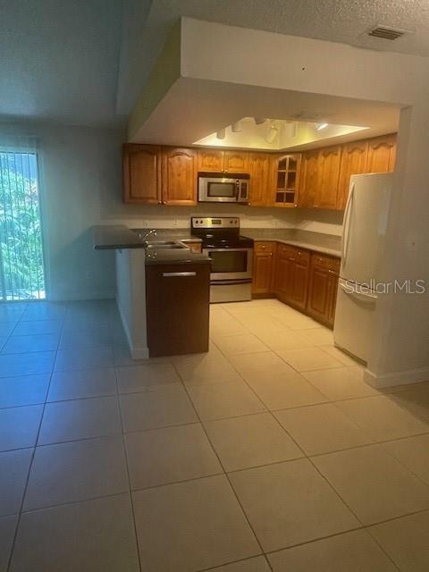 Long view of kitchen/breakfast bar from hallway leading to bedrooms