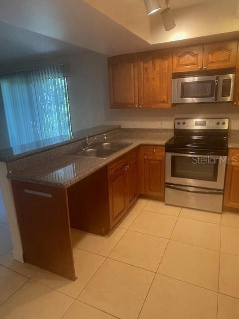 Granite countertops w/ double stainless sink,glass top range, over-the-range microwave.