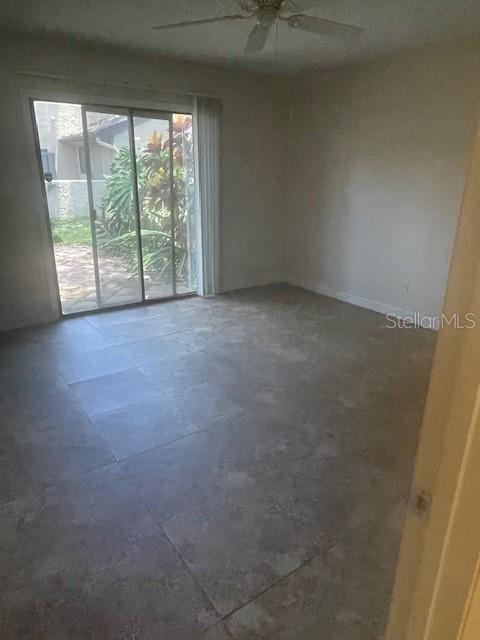 Primary bedroom looking into room from doorway. Glass sliders open to private patio.