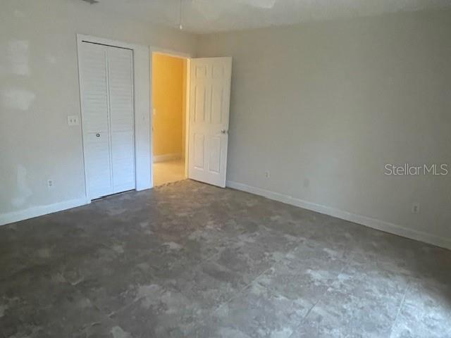 Primary bedroom looking toward hallway. Louvred door opens to walk-in closet. Ensuite bathroom is out of sight to the left.