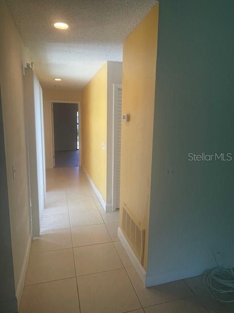 Looking down hallway from the Great Room toward bedrooms....glass sliders on left opposite the short hall on right leading to hall bath and laundry closet.