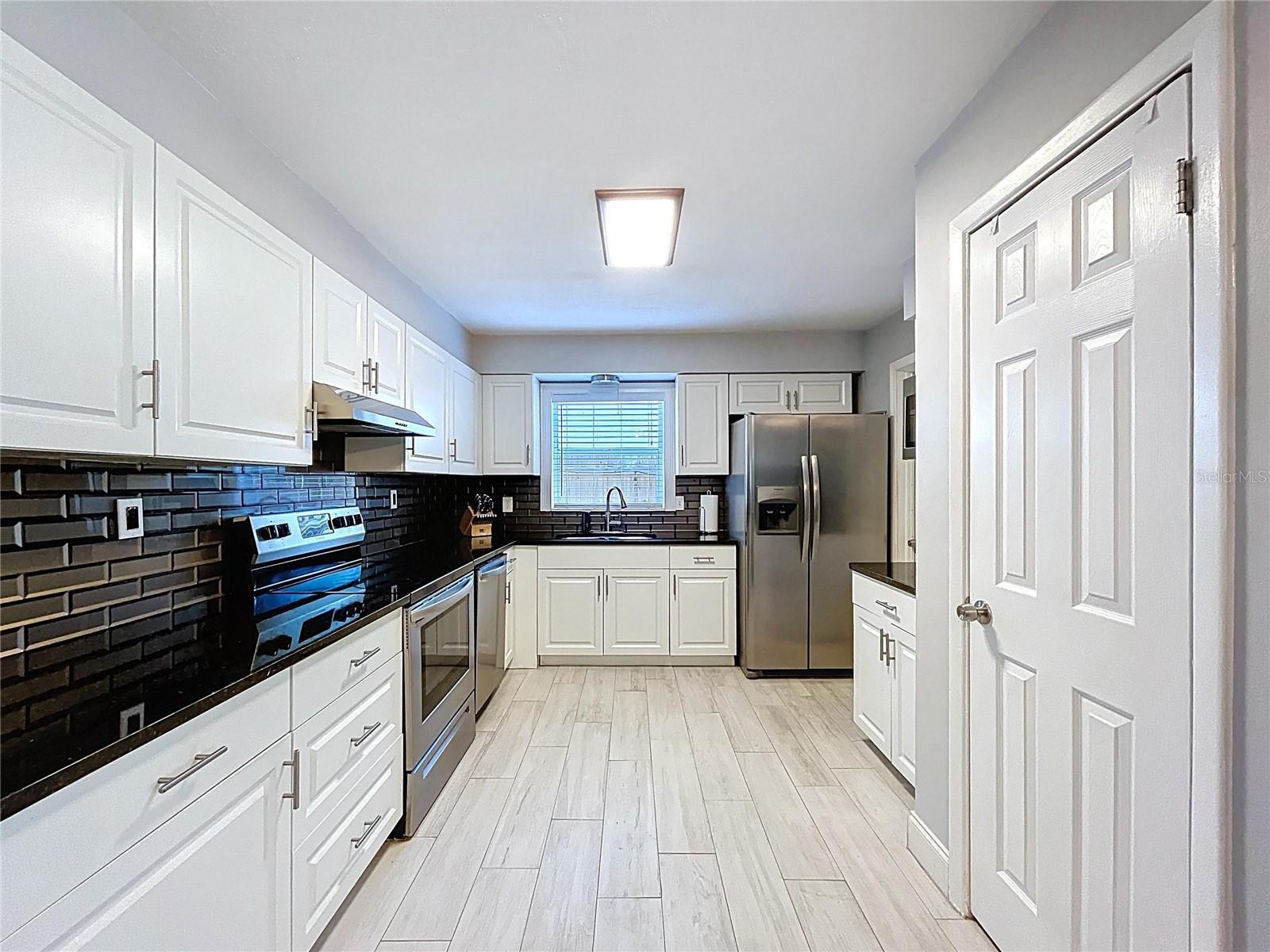 Newer plank tile kitchen flooring.
