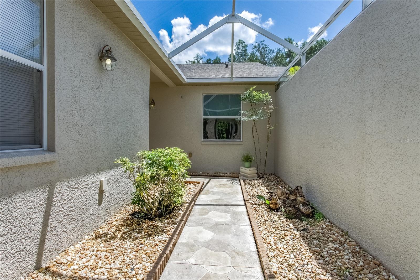 Front entryway screened in courtyard