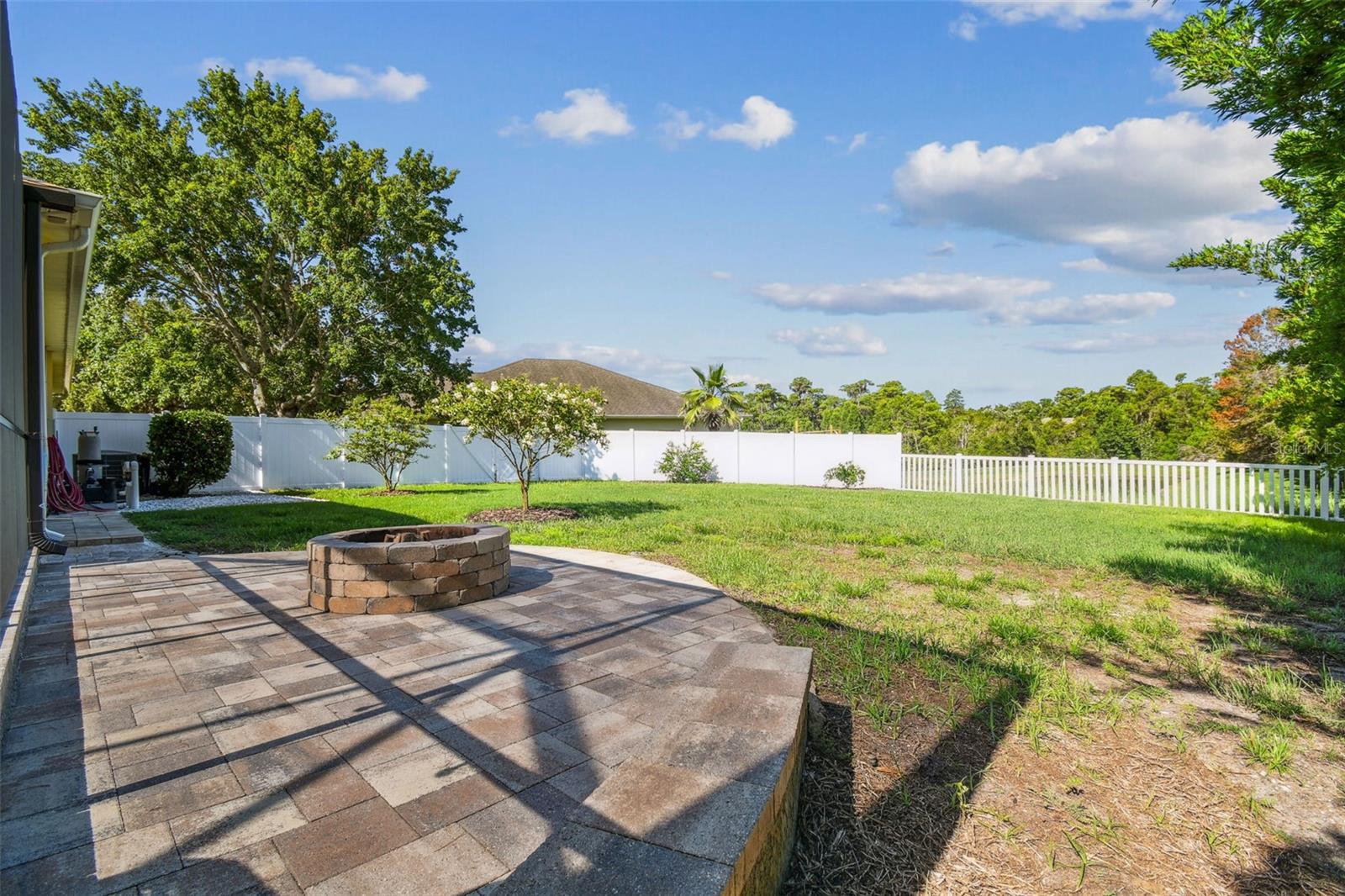 Firepit overlooking the large yard and pond